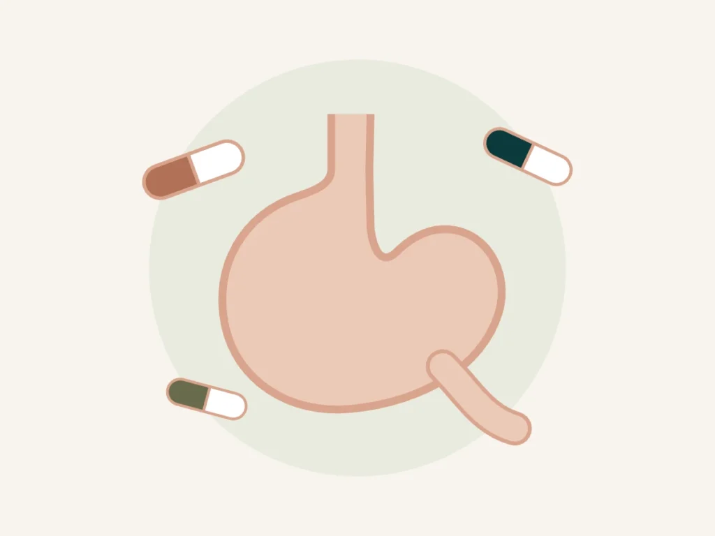 Ilustração do estômago com cápsulas de inibidor de bomba de prótons (omeprazol)